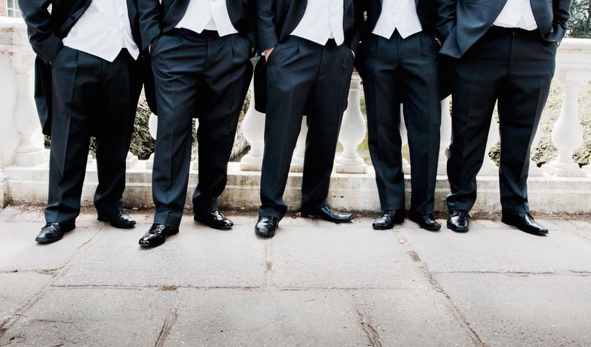 Businessmen with in hands in pocket in row