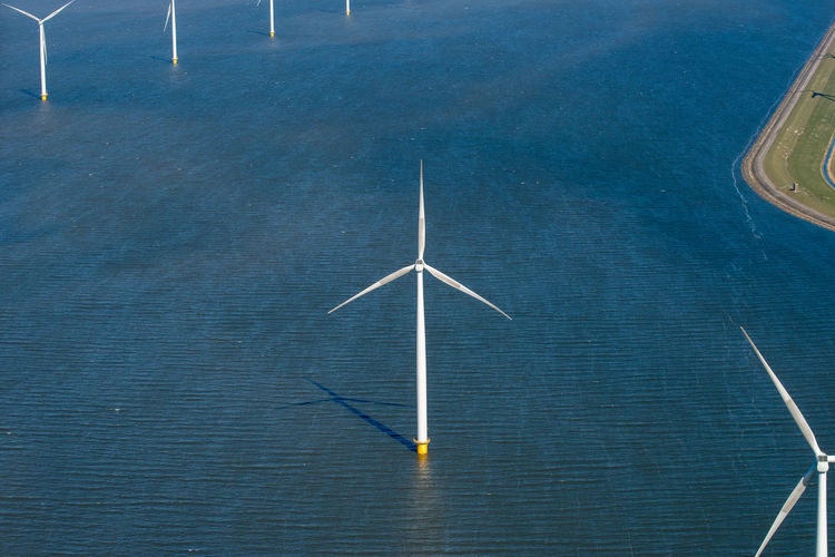 High angle view of wind turbines on sea