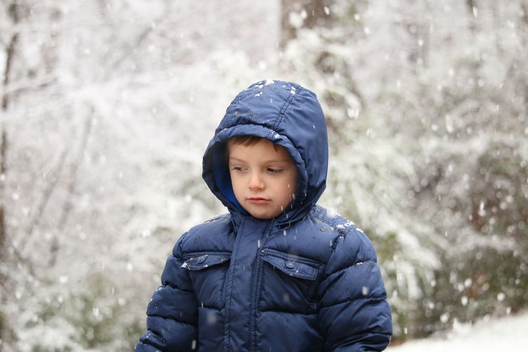 Boy standing in snow