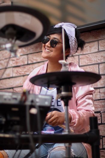 Young woman playing drum