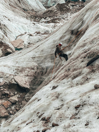 Man standing on rock at mountain