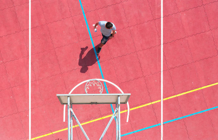 High angle view of person walking on basketball court