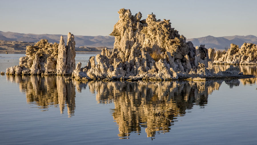 Panoramic view of rock formation in lake against sky