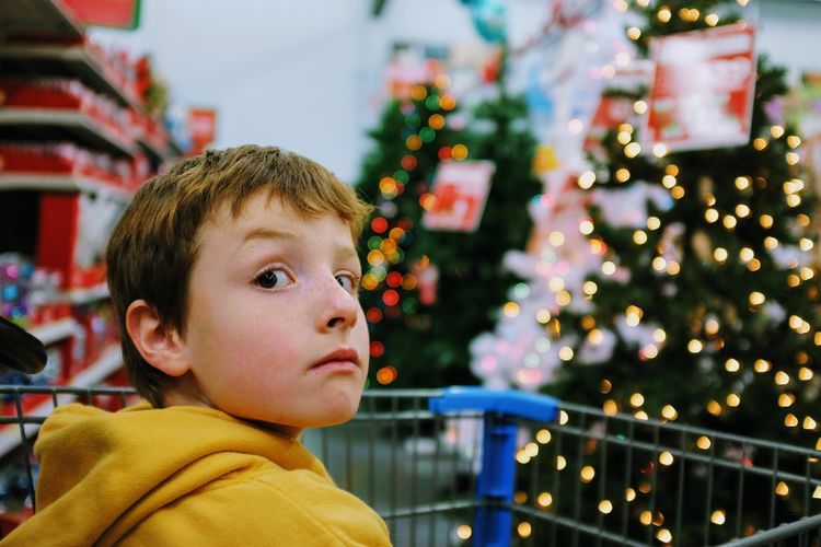 Close-up of boy with christmas tree