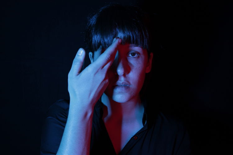 Black Background Casual Clothing Close-up Confidence Cut Out Face Paint Girl Hand Head And Shoulders Headshot Human Face Leisure Activity Lifestyles Portrait Portrait Of A Woman Serious Seriousface Smoke - Physical Structure Studio Shot Woman TCPM