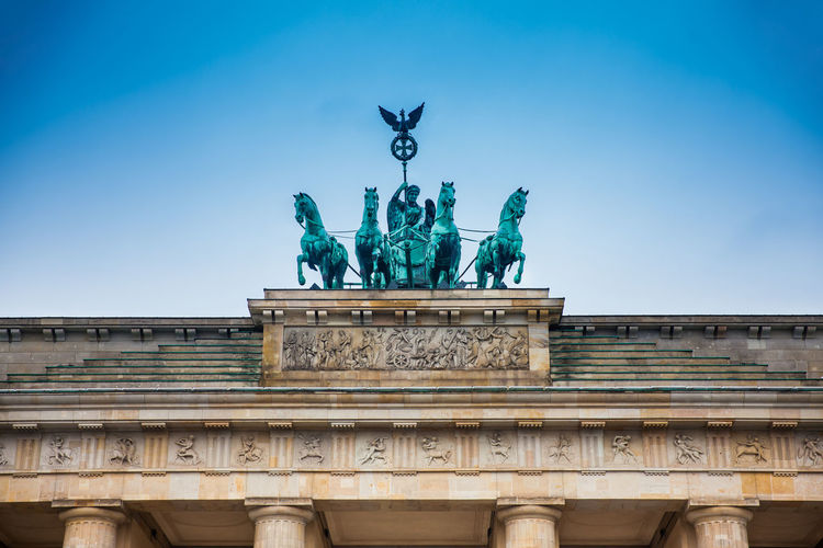 Low angle view of brandenburg gate against blue sky