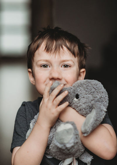 Portrait of cute boy with toy