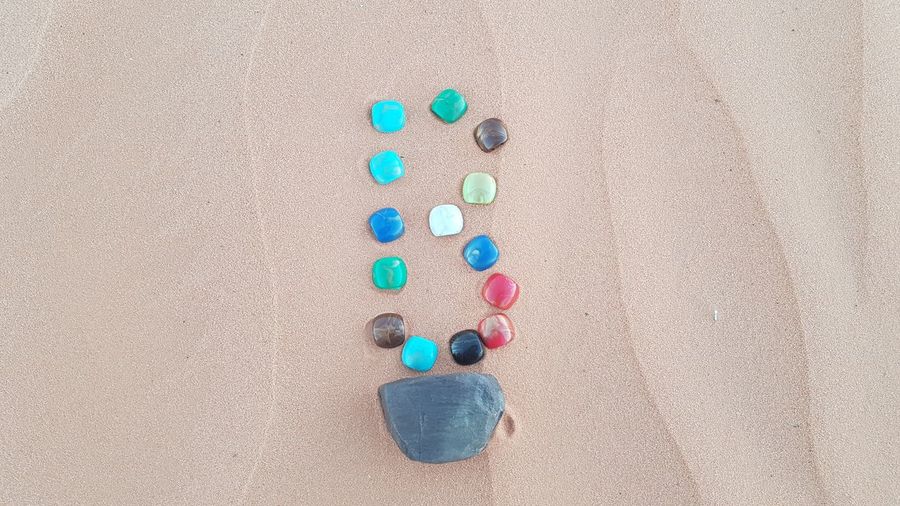 High angle view of multi colored pebbles on sand