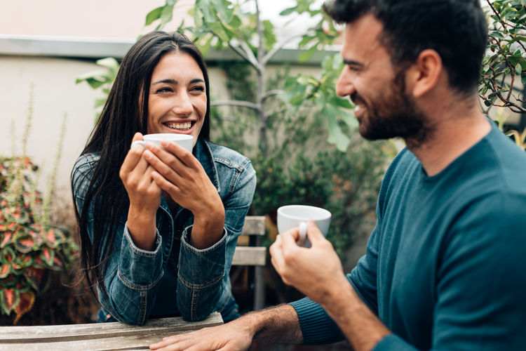 Couple drinking coffee - friends relaxing - work break - meeting casual people