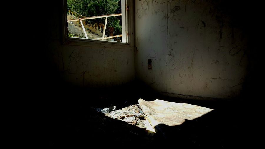 Abandoned building seen through broken window