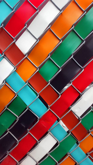 Multi colored ribbon through fencing