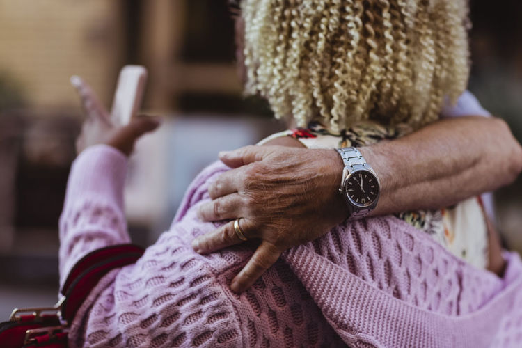 Senior man's hand around woman