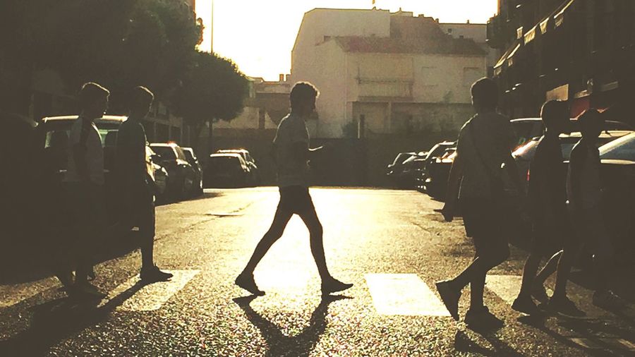 Silhouette of people walking on street