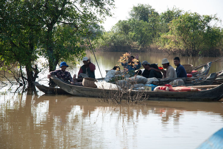 People sitting on boat in river