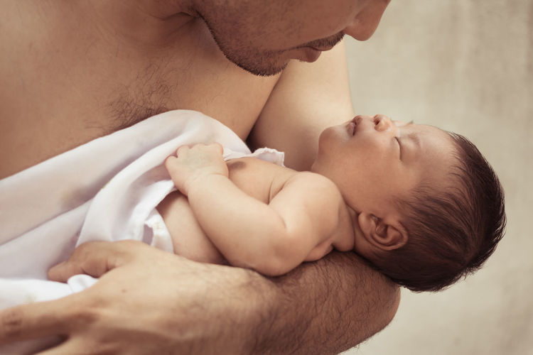Close-up of father holding baby