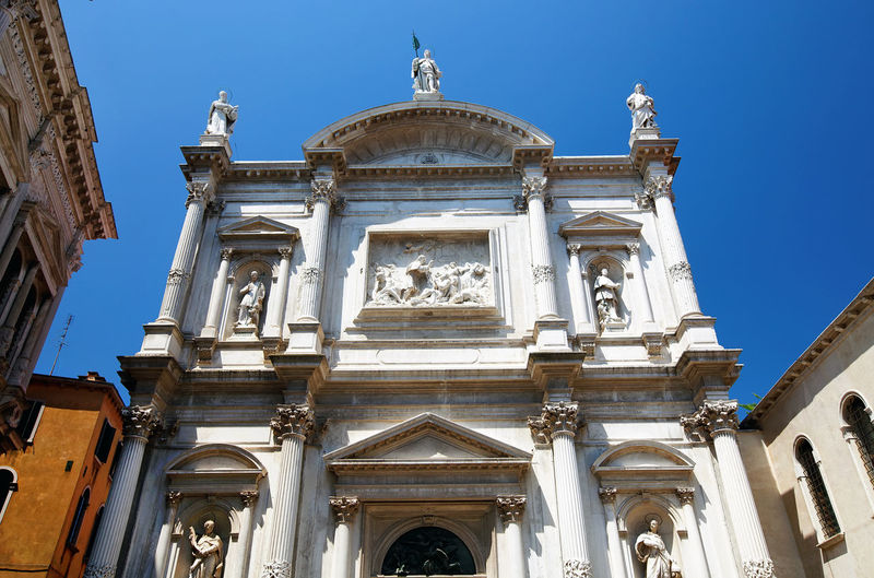 Low angle view of scuola grande di san rocco museum against clear blue sky