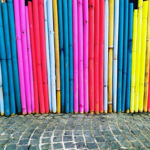 Colorful wooden fence by road