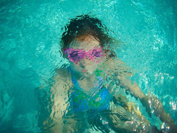 Close-up portrait of boy swimming in pool