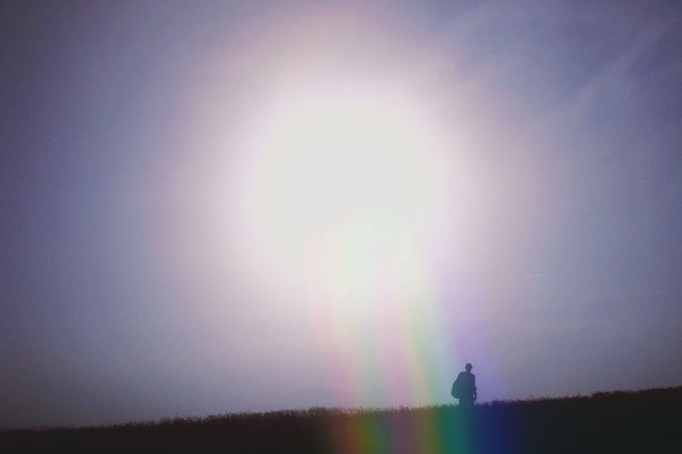 Scenic view of rainbow over landscape against sky