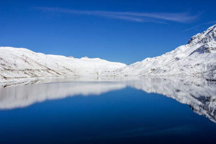 Scenic view of mountains against clear blue sky