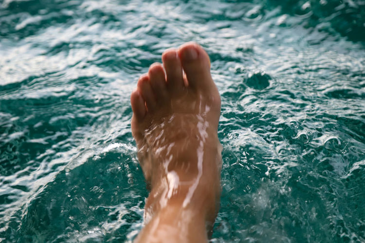 Low section of person in swimming pool
