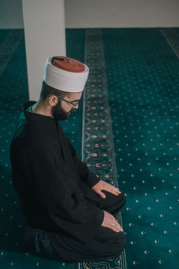 High angle view of man praying at mosque