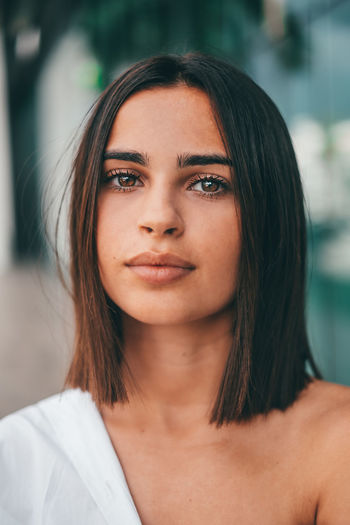 Close-up portrait of young woman looking at camera