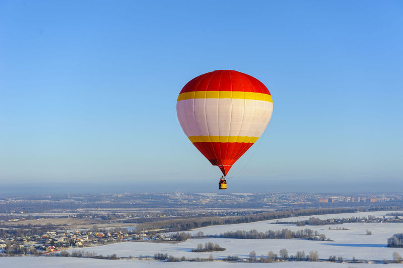 Hot air balloon flying against blue sky
