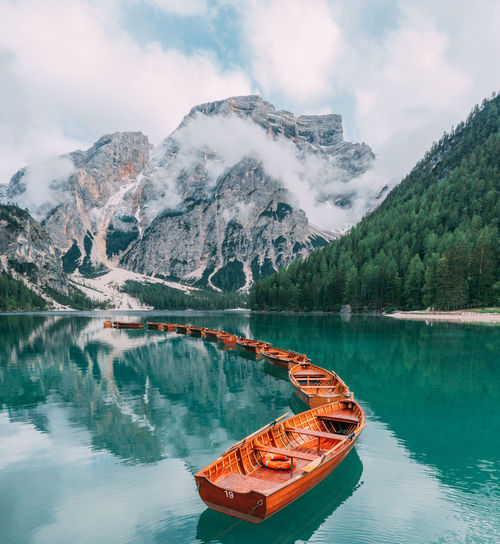Natural landscapes of the mountain lake braies in the dolomites, italy. boats on the mountain lake 