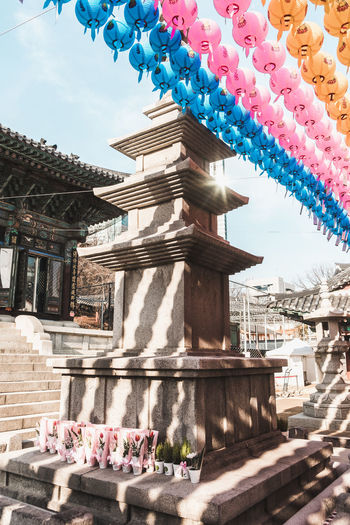 Ancient monument on seoul street. multicolored chinese lanterns. monument in asian city.