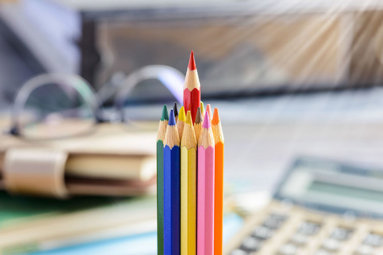 Close-up of multi colored pencils on table