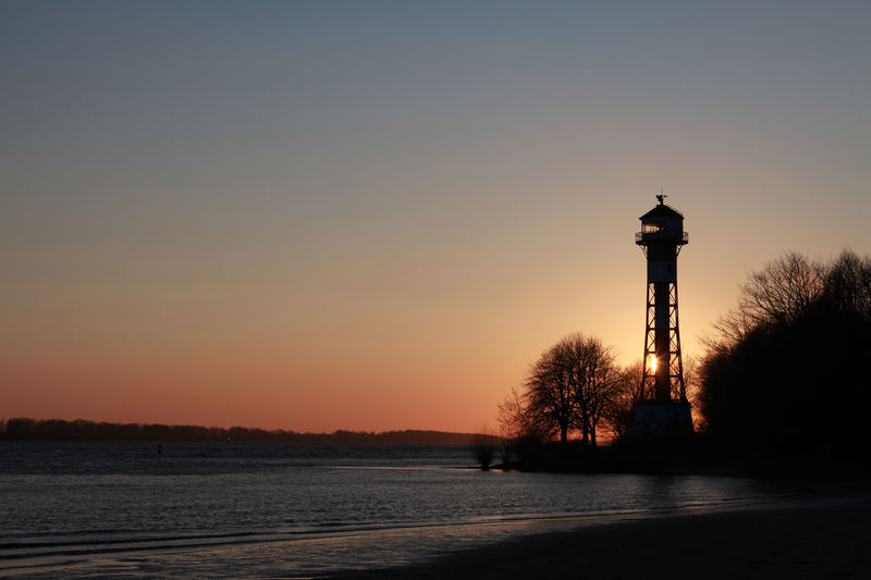 Scenic view of sea against clear sky during sunset