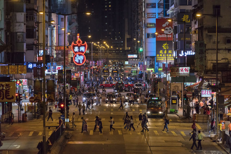 Group of people walking on road in city at night