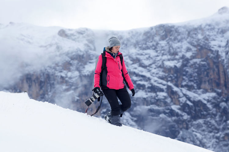 Female photographer in winter landscape