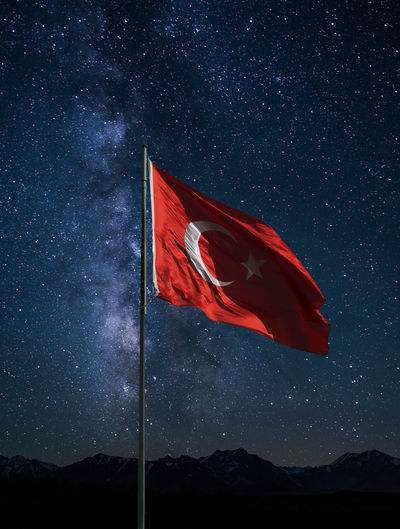 Turkish flag waving under the stars at night