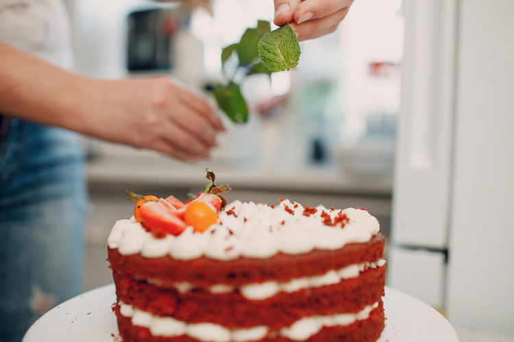 Cropped image of hand holding cake