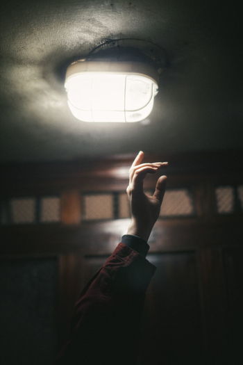 Cropped hand gesturing on illuminated lighting equipment