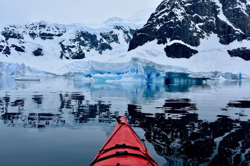 Cropped image of boat on lake against glacier