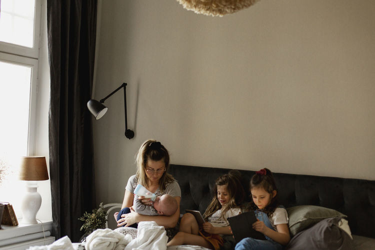 Mother with children on bed