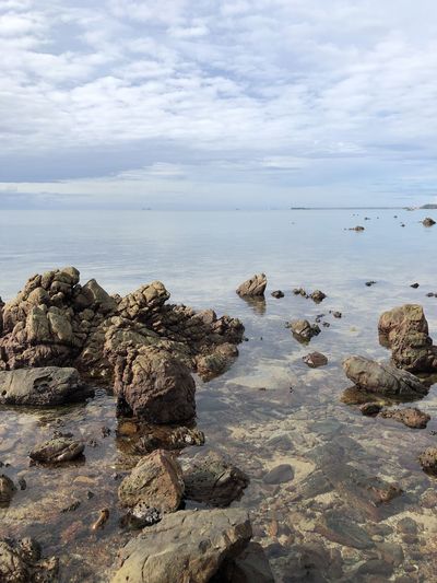 Rocks on beach against sky