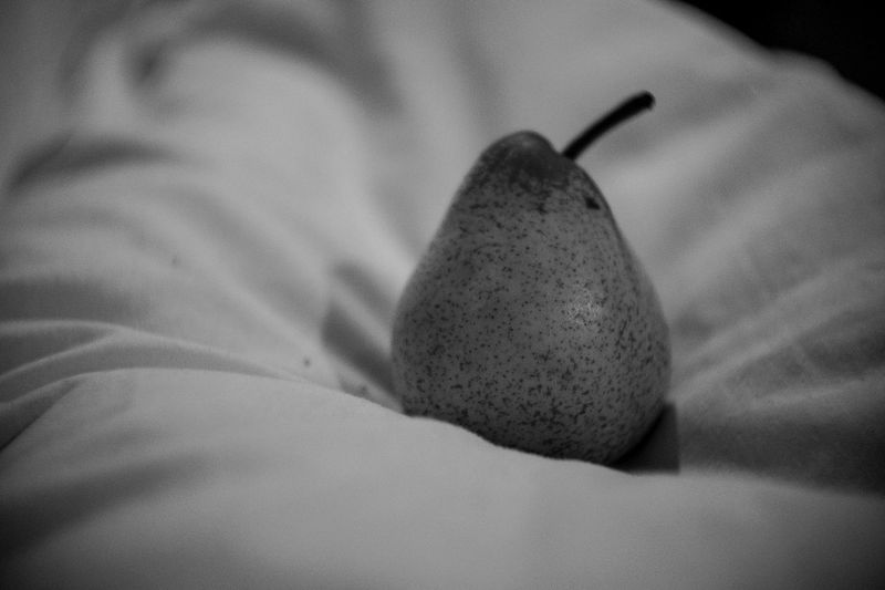 Close-up of apple on bed