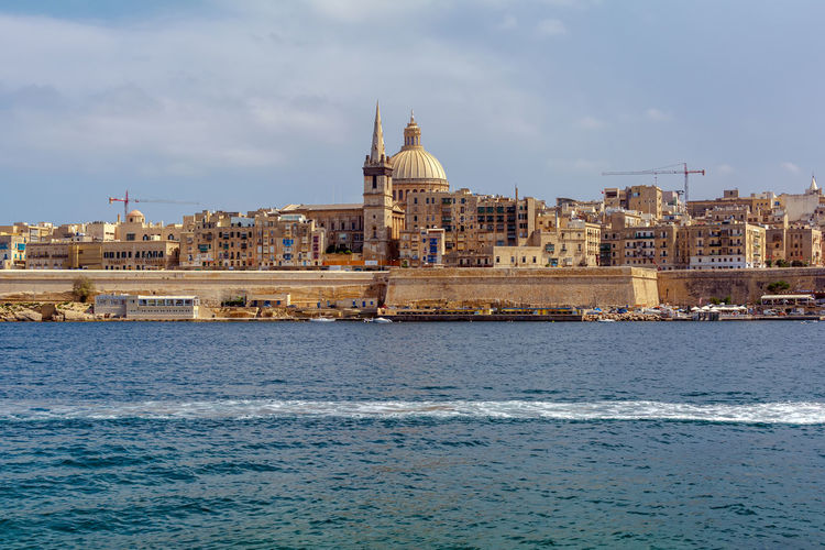 Valletta city, shot from fort manoel beach, with traditional architecture of yellow limestone