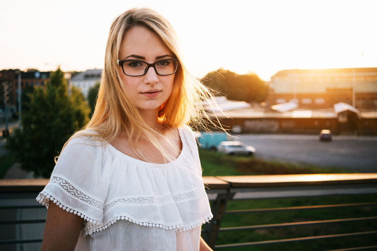 Portrait of young woman standing in park