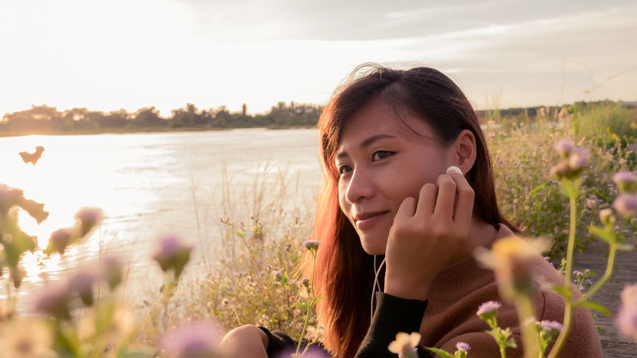 Portrait of beautiful woman against sky
