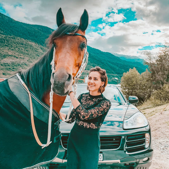 Portrait of smiling young woman with horse