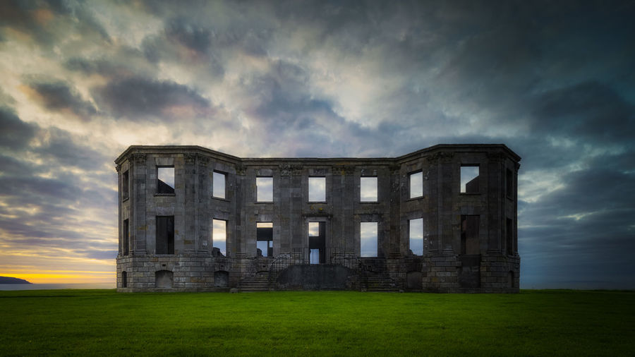 Ruins of downhill demesne with dramatic, moody sunset, northern ireland