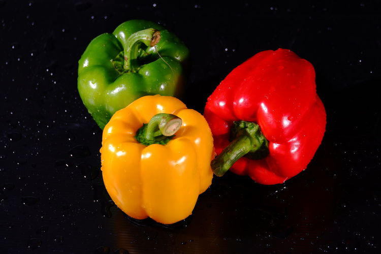 Close-up of bell peppers against black background