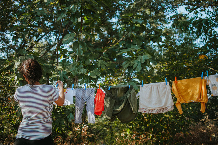 Rear view of woman drying clothes