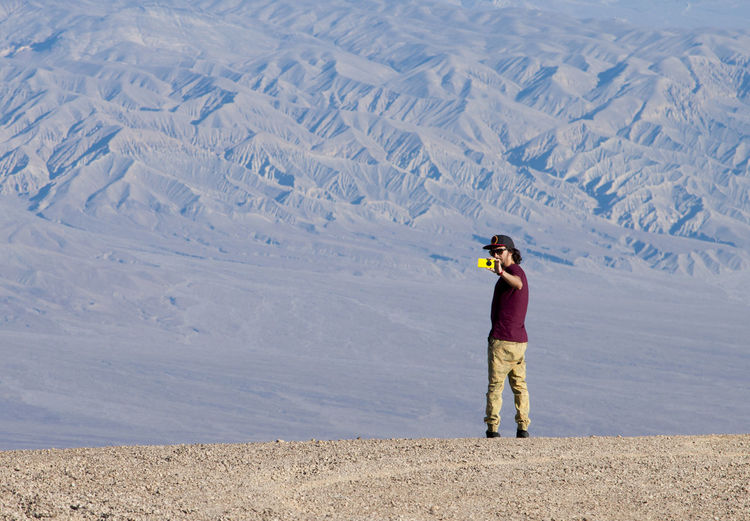 Man photographing on desert landscape