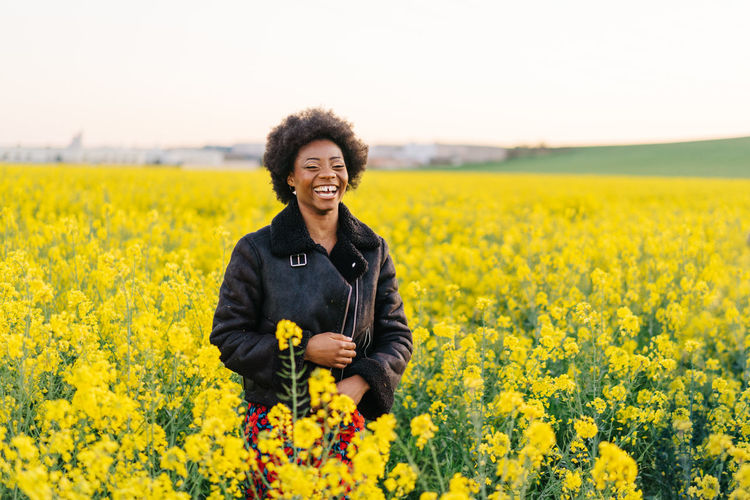 Laughing woman standing on field